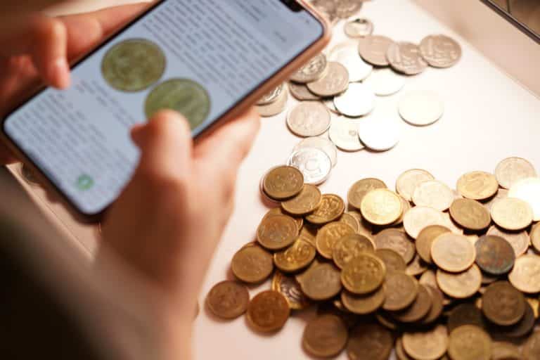 Checking and inspecting different coins, searching for a rare coin, numismatic