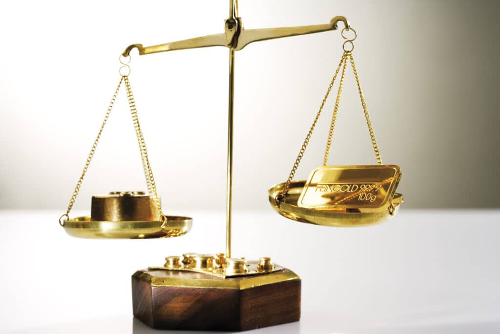 Gold bar on a a pair of scales