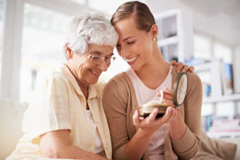 This is their family heirloom. Cropped shot of a senior woman giving her daughter a pearl necklace.